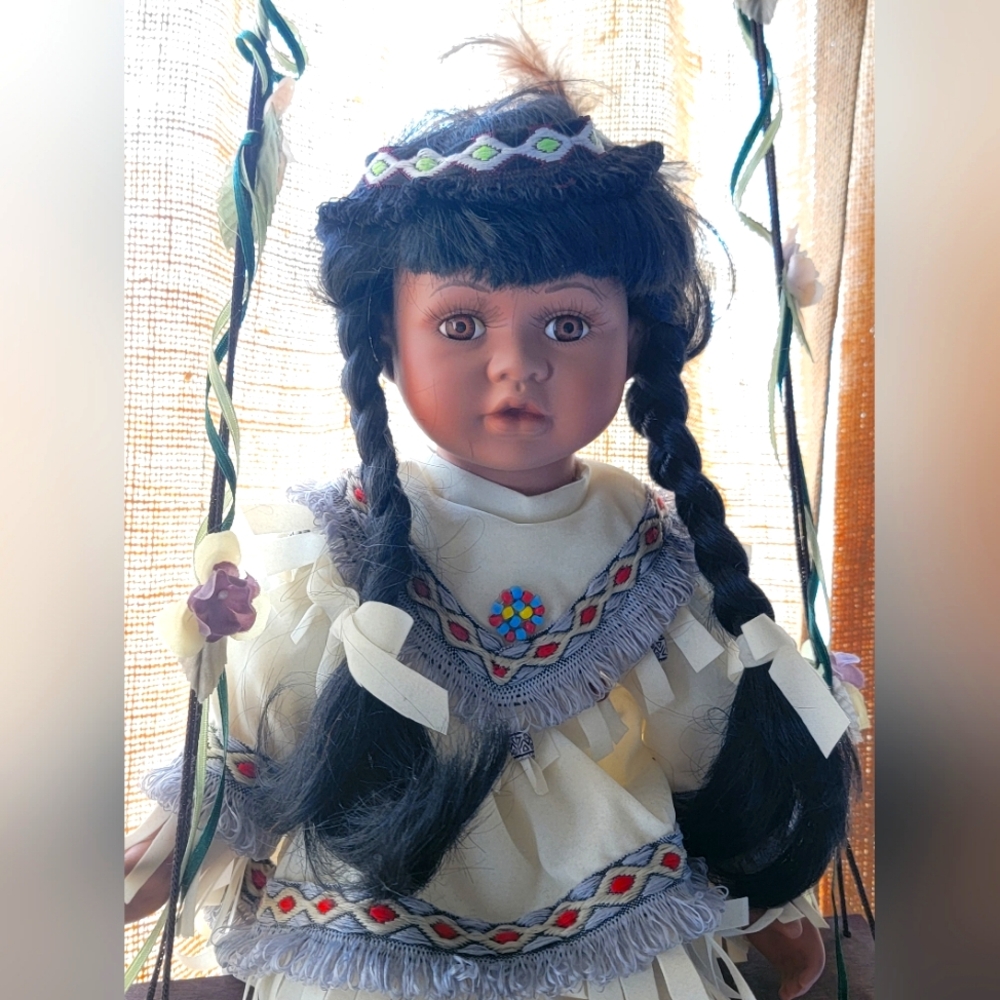Cathay Collection Porcelain Native American Indian Doll on swing.